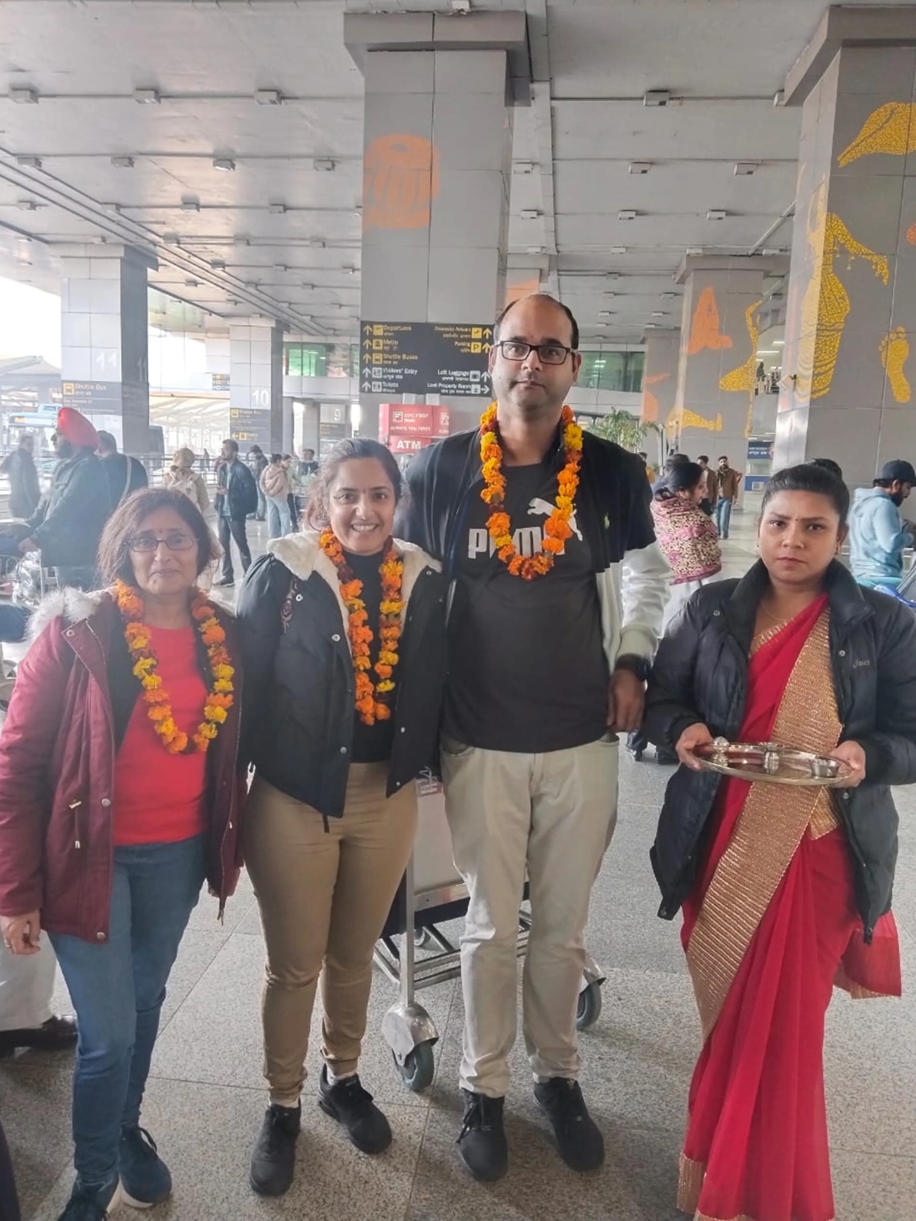Person with marigold garland
